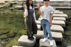 Javeria and Sakhawat posing on the steps of Cheonggyecheon